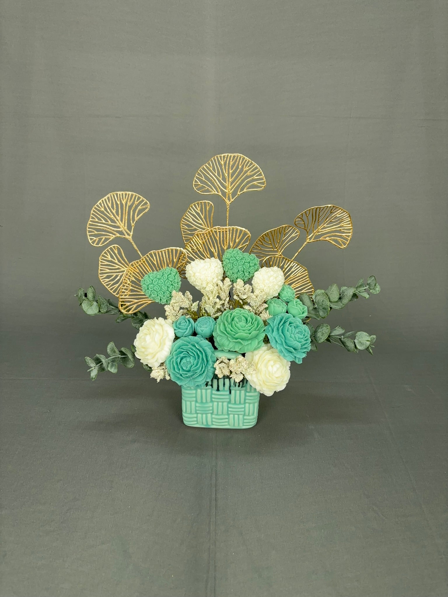 Shades of Green mint and white candle bouquet with gold leaf backdrop, eucalyptus and basket-style ceramic vase