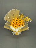 Sunflower Bloom yellow sunflower-style candle bouquet with white hydrangeas and pearl bow wrapping